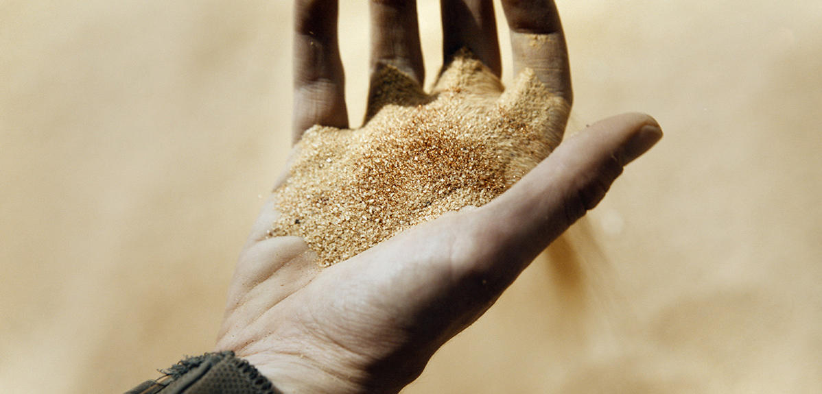 a hand holding spice melange from the movie Dune